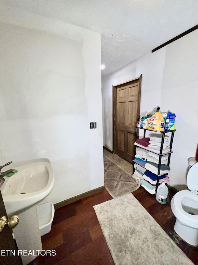 bathroom with hardwood / wood-style flooring and toilet