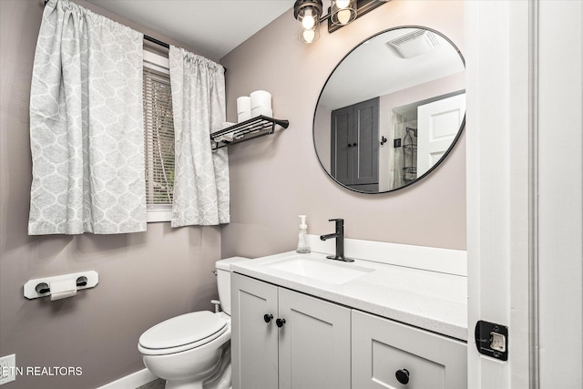 bathroom with vanity and toilet