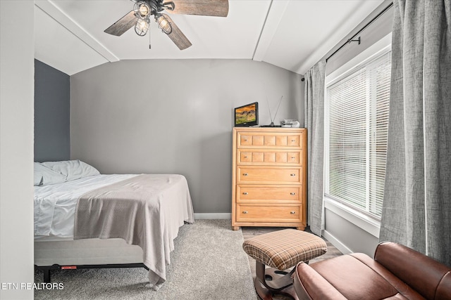 bedroom featuring ceiling fan, multiple windows, and vaulted ceiling