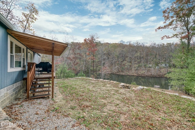 view of yard featuring a deck with water view