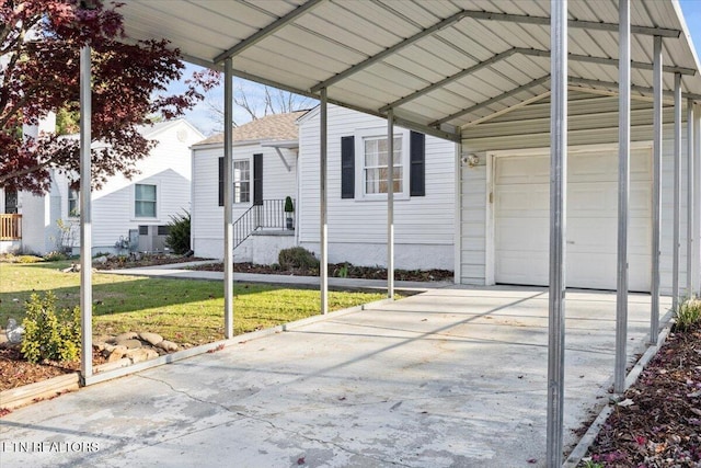 view of side of home with a yard, a carport, and a garage