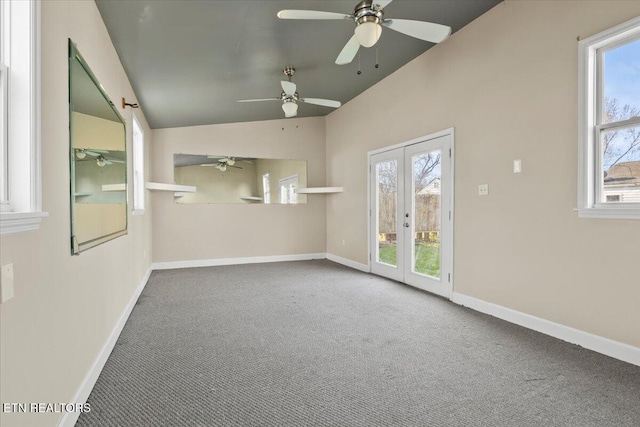 empty room with a wealth of natural light, french doors, and carpet floors