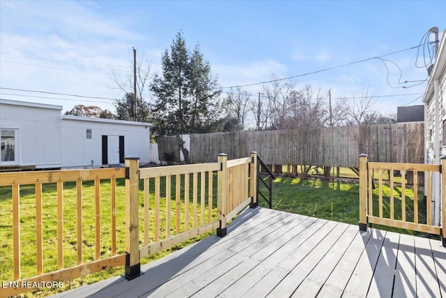 wooden terrace with a lawn