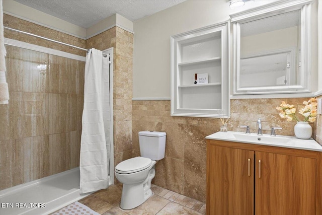 bathroom featuring tile patterned flooring, a textured ceiling, tile walls, and curtained shower