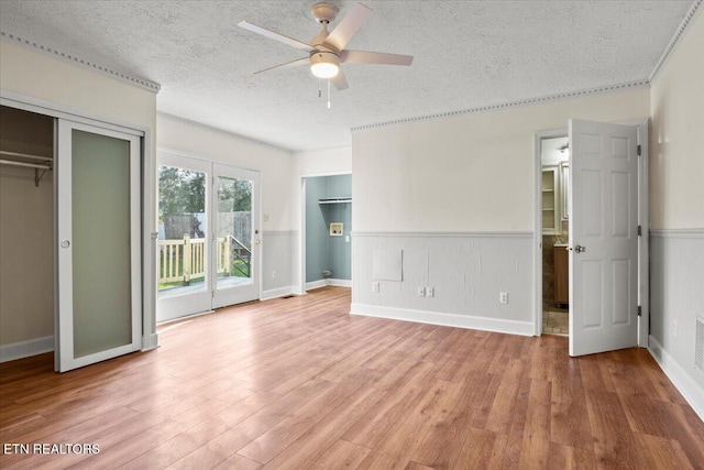 unfurnished bedroom featuring a textured ceiling, light hardwood / wood-style flooring, and a closet