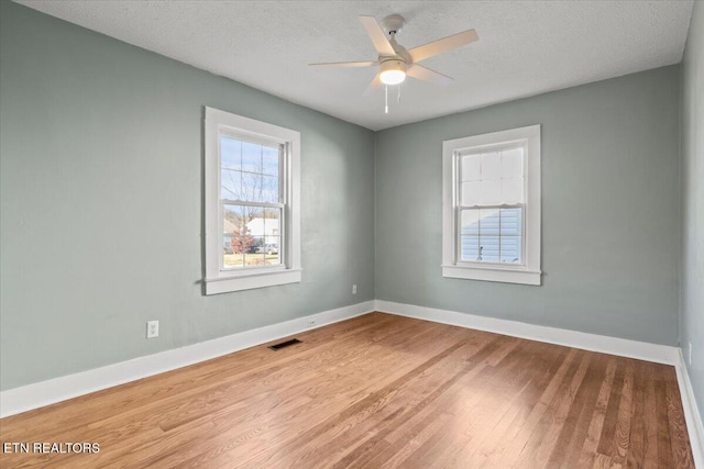 spare room featuring ceiling fan, a textured ceiling, and hardwood / wood-style flooring