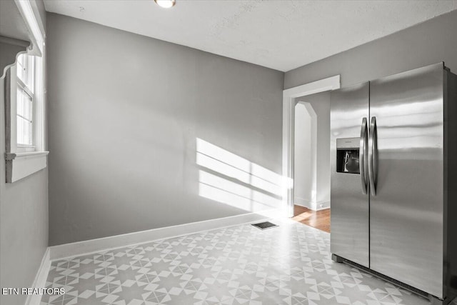 kitchen with stainless steel refrigerator with ice dispenser