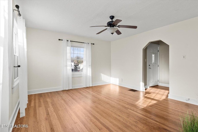 unfurnished room featuring ceiling fan, a textured ceiling, and light wood-type flooring