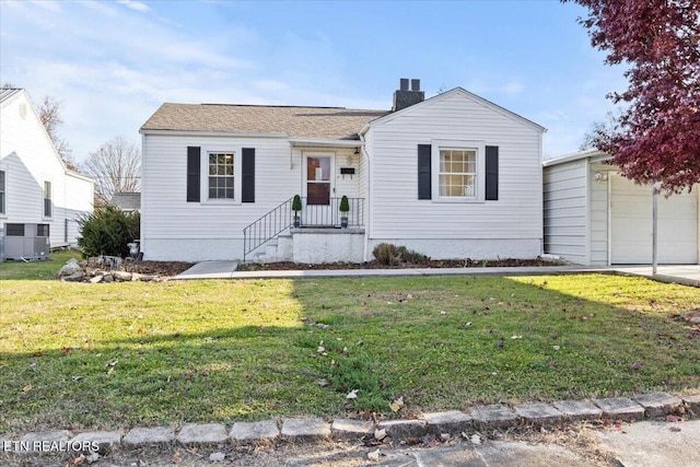 view of front of property with a front yard and a garage