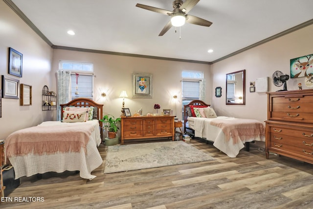 bedroom featuring ceiling fan, crown molding, and wood-type flooring