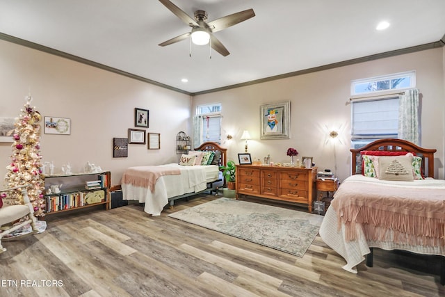 bedroom with hardwood / wood-style flooring, ceiling fan, and ornamental molding