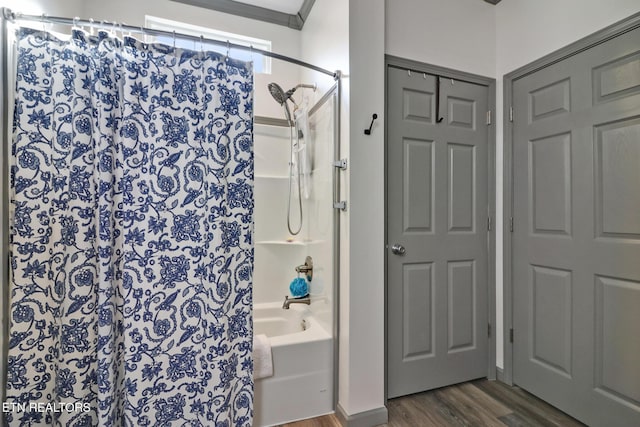 bathroom featuring wood-type flooring and shower / bath combo