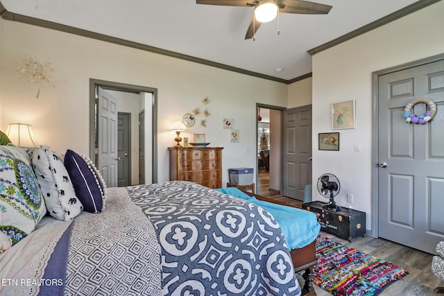 bedroom featuring hardwood / wood-style flooring, ceiling fan, and ornamental molding