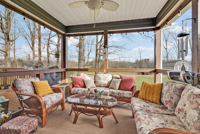 sunroom / solarium featuring ceiling fan, wooden ceiling, and a wealth of natural light