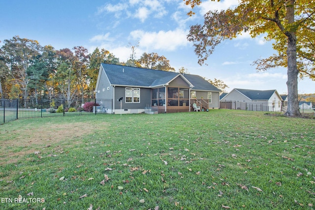 back of house with a sunroom and a yard