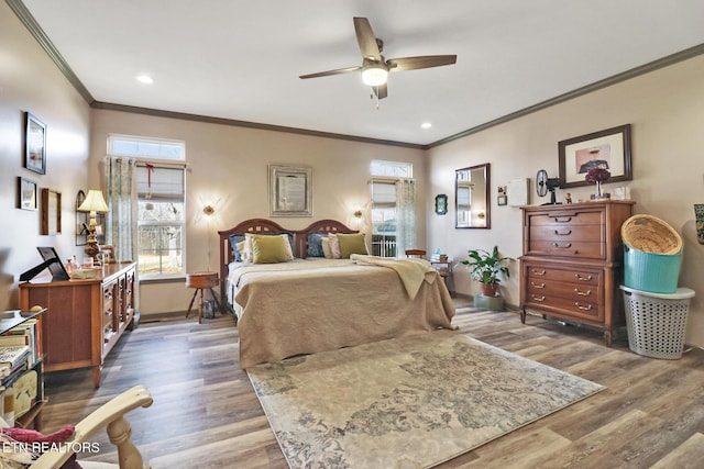 bedroom with dark hardwood / wood-style flooring, ornamental molding, and ceiling fan