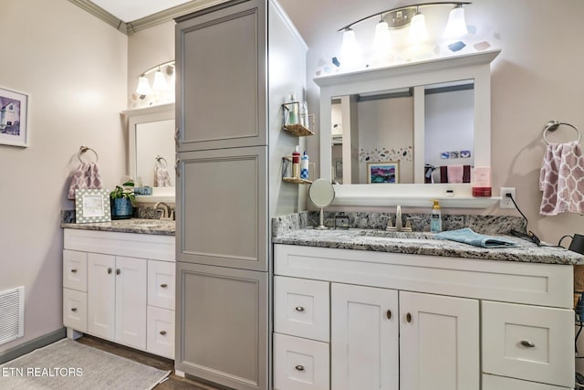 bathroom featuring vanity and ornamental molding