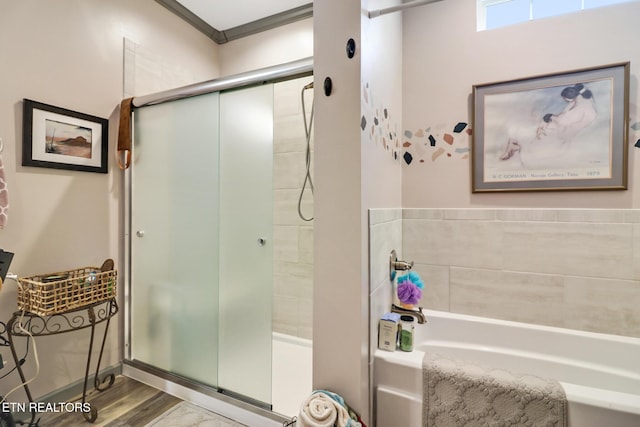 bathroom featuring hardwood / wood-style floors and shower with separate bathtub