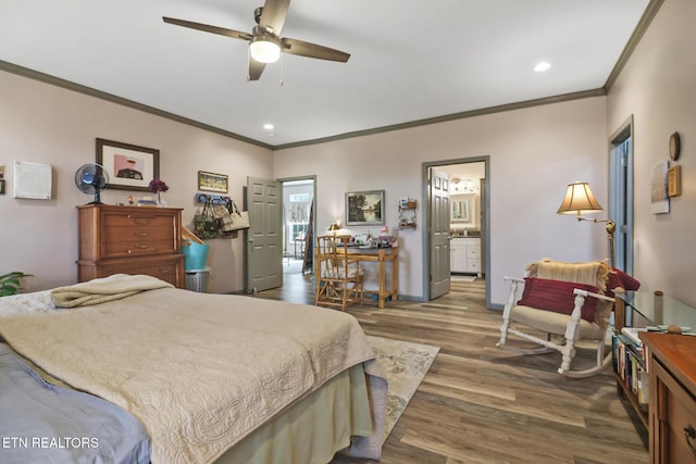 bedroom featuring ornamental molding, dark wood-type flooring, connected bathroom, and ceiling fan