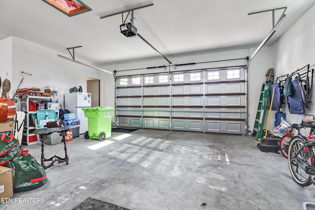 garage with a garage door opener and white fridge