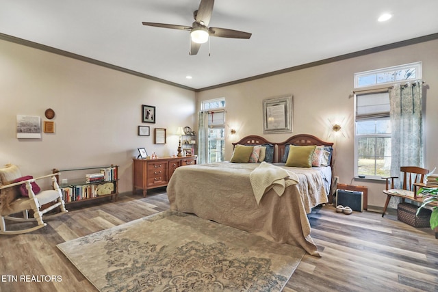 bedroom featuring ornamental molding, hardwood / wood-style floors, and ceiling fan