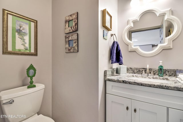 bathroom featuring vanity and toilet