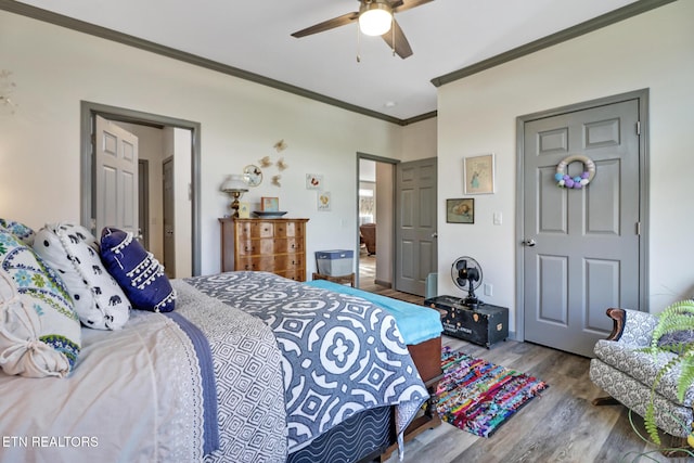 bedroom featuring light hardwood / wood-style flooring, ornamental molding, and ceiling fan