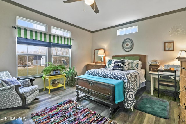 bedroom with crown molding, hardwood / wood-style floors, and ceiling fan