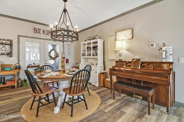 dining room featuring hardwood / wood-style floors, crown molding, and french doors