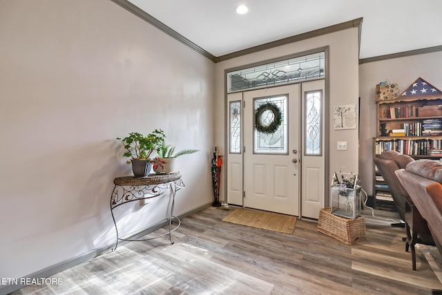 foyer entrance featuring hardwood / wood-style flooring and ornamental molding