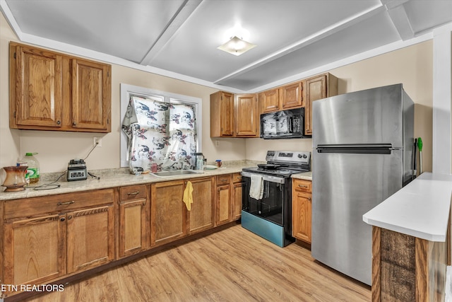 kitchen with light wood-type flooring, sink, and appliances with stainless steel finishes