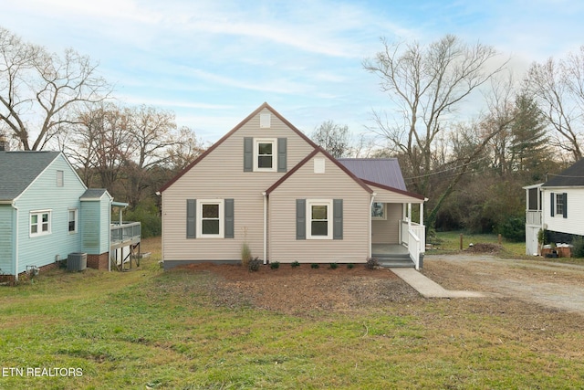 view of front facade with central AC unit and a front lawn