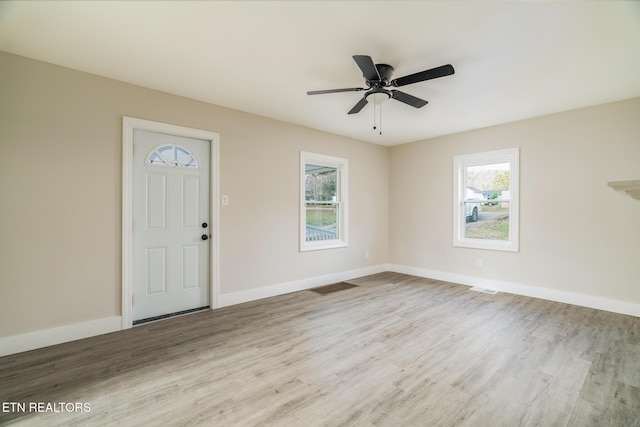 foyer entrance featuring ceiling fan and light wood-type flooring