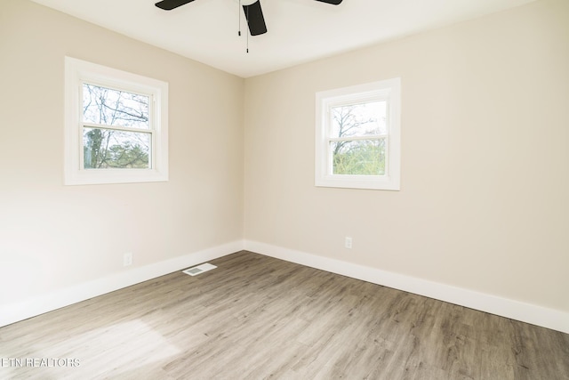 spare room featuring ceiling fan and light hardwood / wood-style flooring