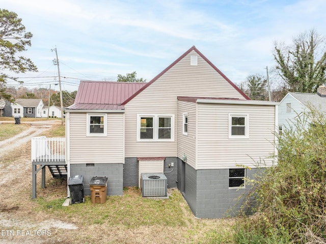 back of house with cooling unit and a deck