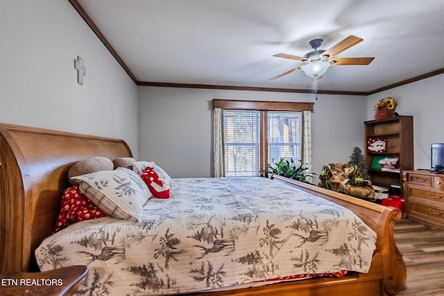 bedroom featuring ceiling fan, wood-type flooring, and ornamental molding