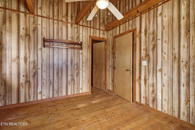 empty room with ceiling fan and hardwood / wood-style flooring