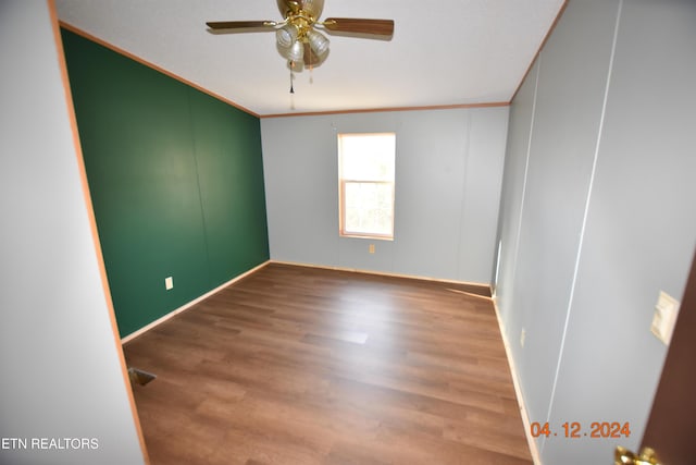 unfurnished room with hardwood / wood-style floors, ceiling fan, and crown molding