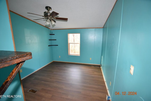 empty room featuring dark hardwood / wood-style floors, ceiling fan, ornamental molding, and a textured ceiling