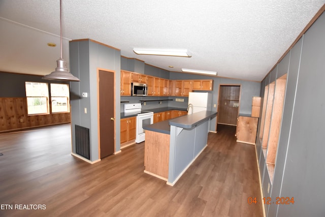 kitchen with a center island, dark wood-type flooring, a textured ceiling, lofted ceiling, and white appliances