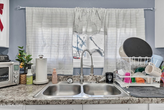 kitchen with sink and white cabinets