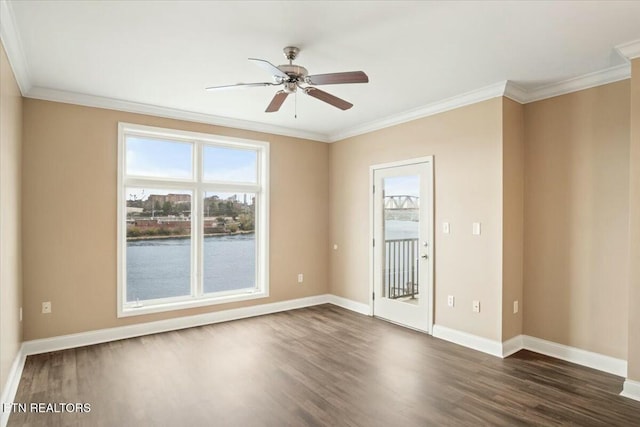 empty room featuring ceiling fan, a water view, dark wood-type flooring, and ornamental molding