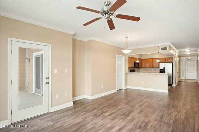 unfurnished living room with hardwood / wood-style flooring, ceiling fan, and crown molding