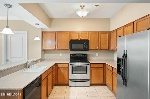 kitchen featuring pendant lighting, sink, light tile patterned floors, and black appliances