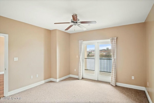 carpeted empty room featuring ceiling fan