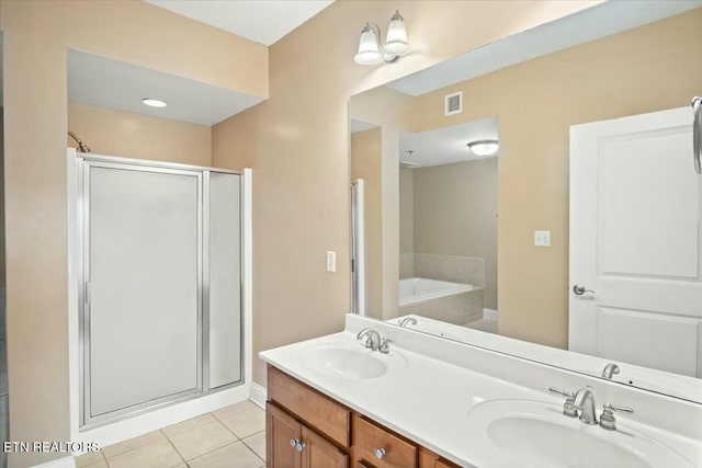 bathroom with tile patterned flooring, shower with separate bathtub, and vanity