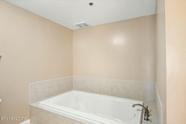 bathroom with tiled tub