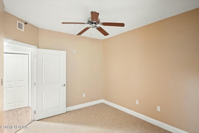 unfurnished bedroom with ceiling fan and light colored carpet