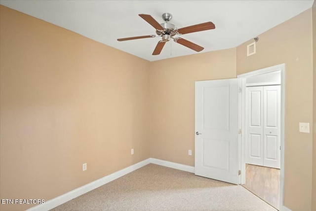 carpeted empty room with ceiling fan