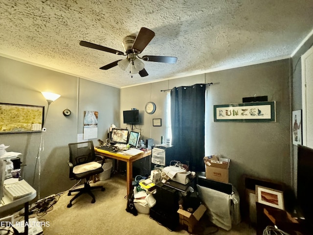 home office featuring carpet, ceiling fan, ornamental molding, and a textured ceiling